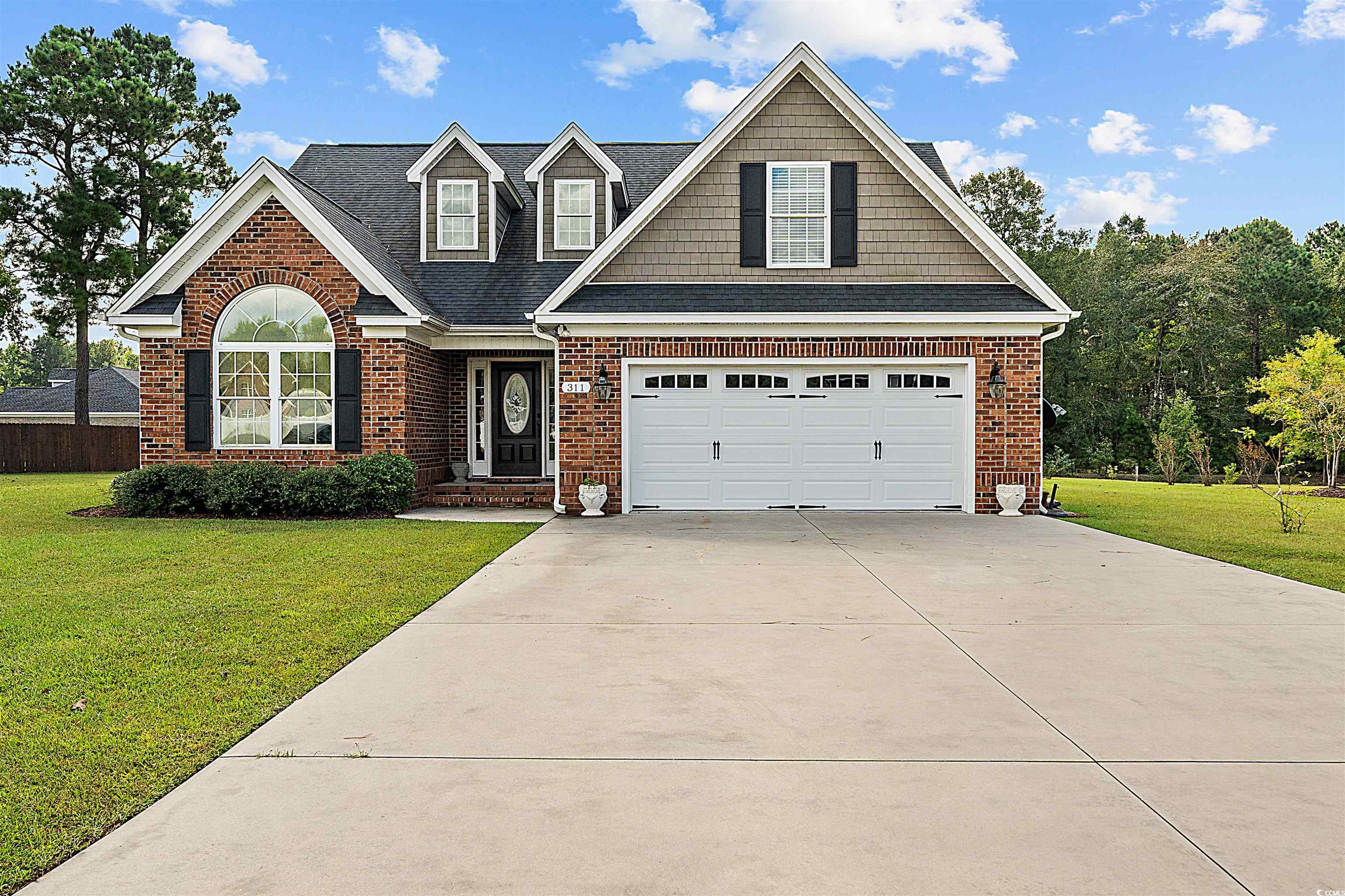 View of front of house with a garage and a front l