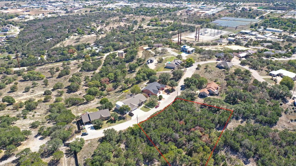 an aerial view of residential houses with city view