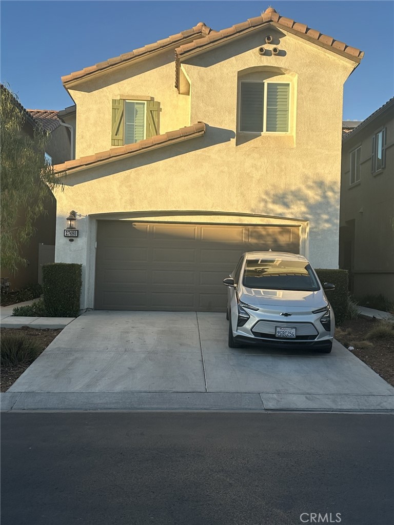 a view of a car parked in front of a house