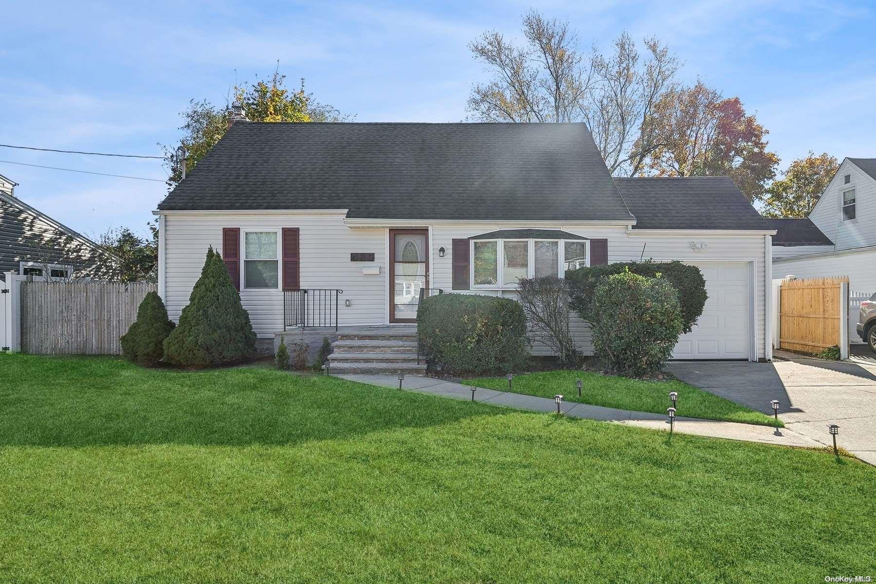 a view of a house with a backyard