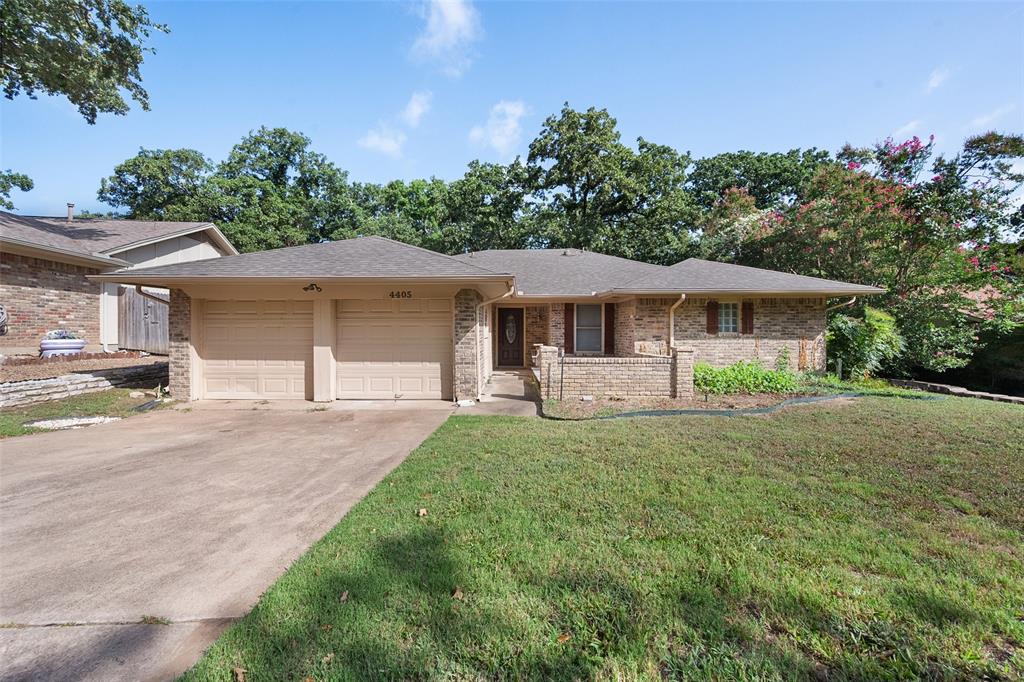 a front view of a house with yard patio and green space