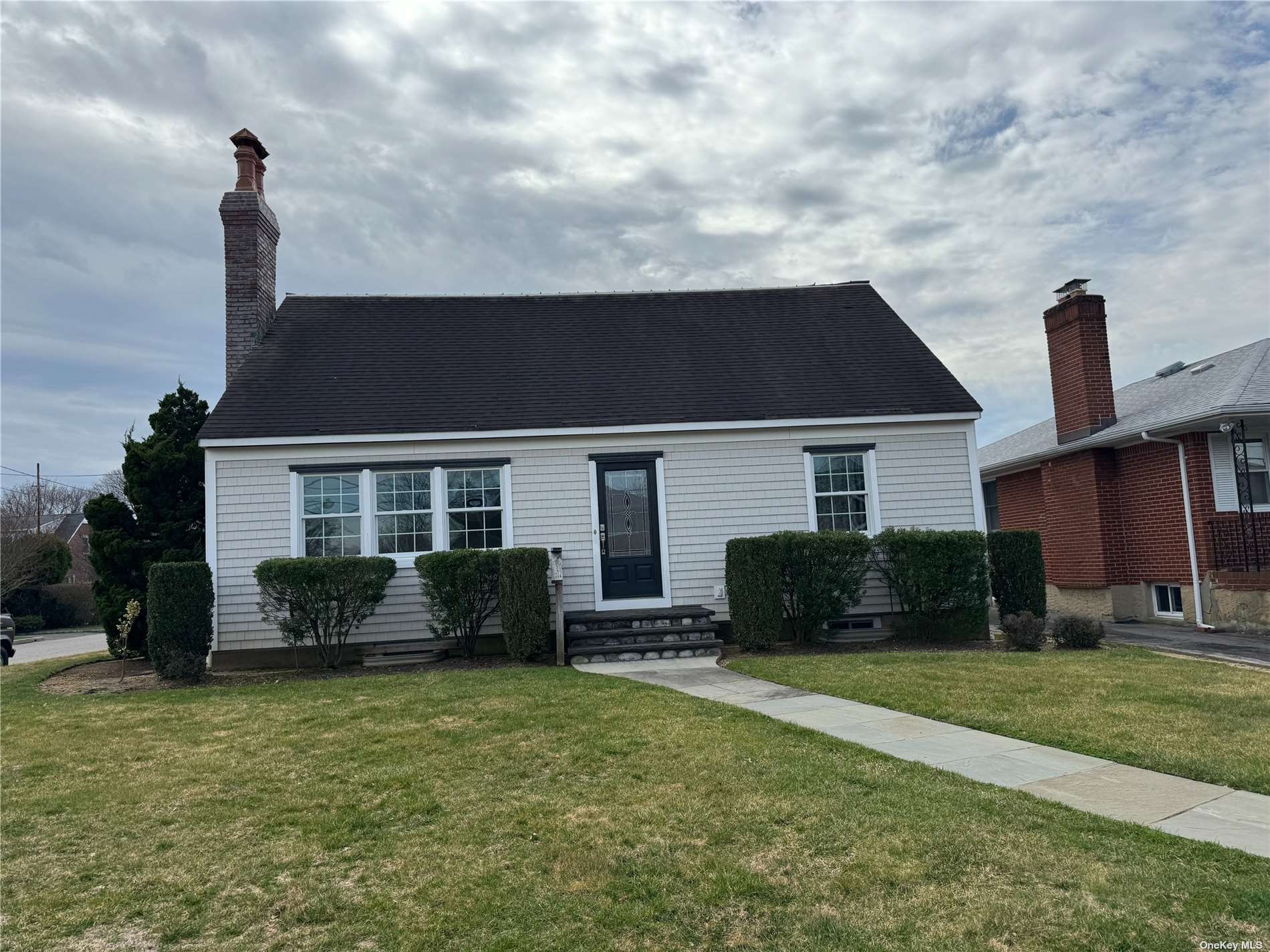 a front view of a house with a garden