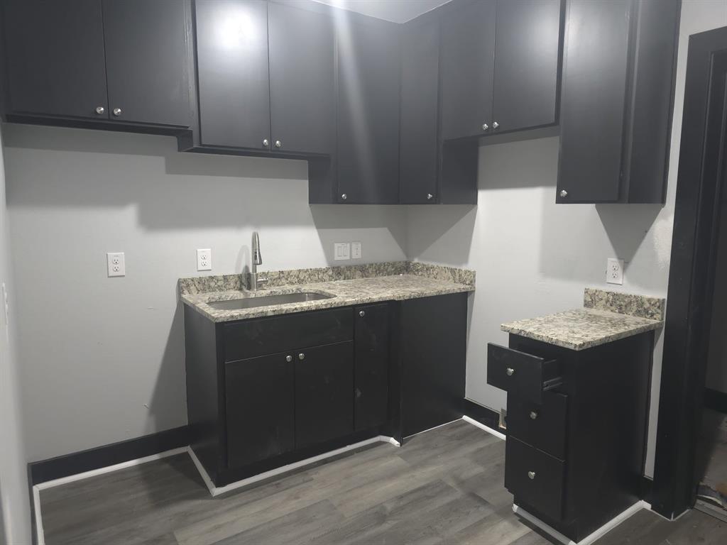 a kitchen with a sink and a refrigerator