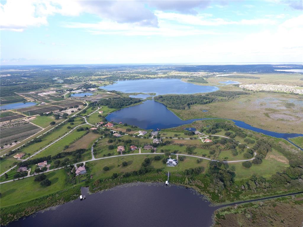 an aerial view of ocean with residential houses with outdoor space