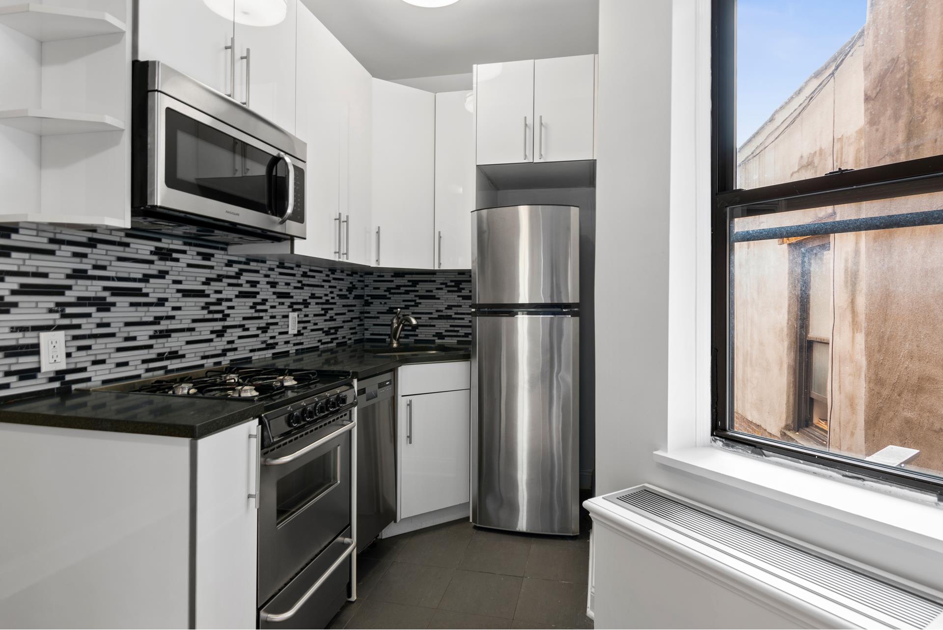 a kitchen with a refrigerator stove and microwave