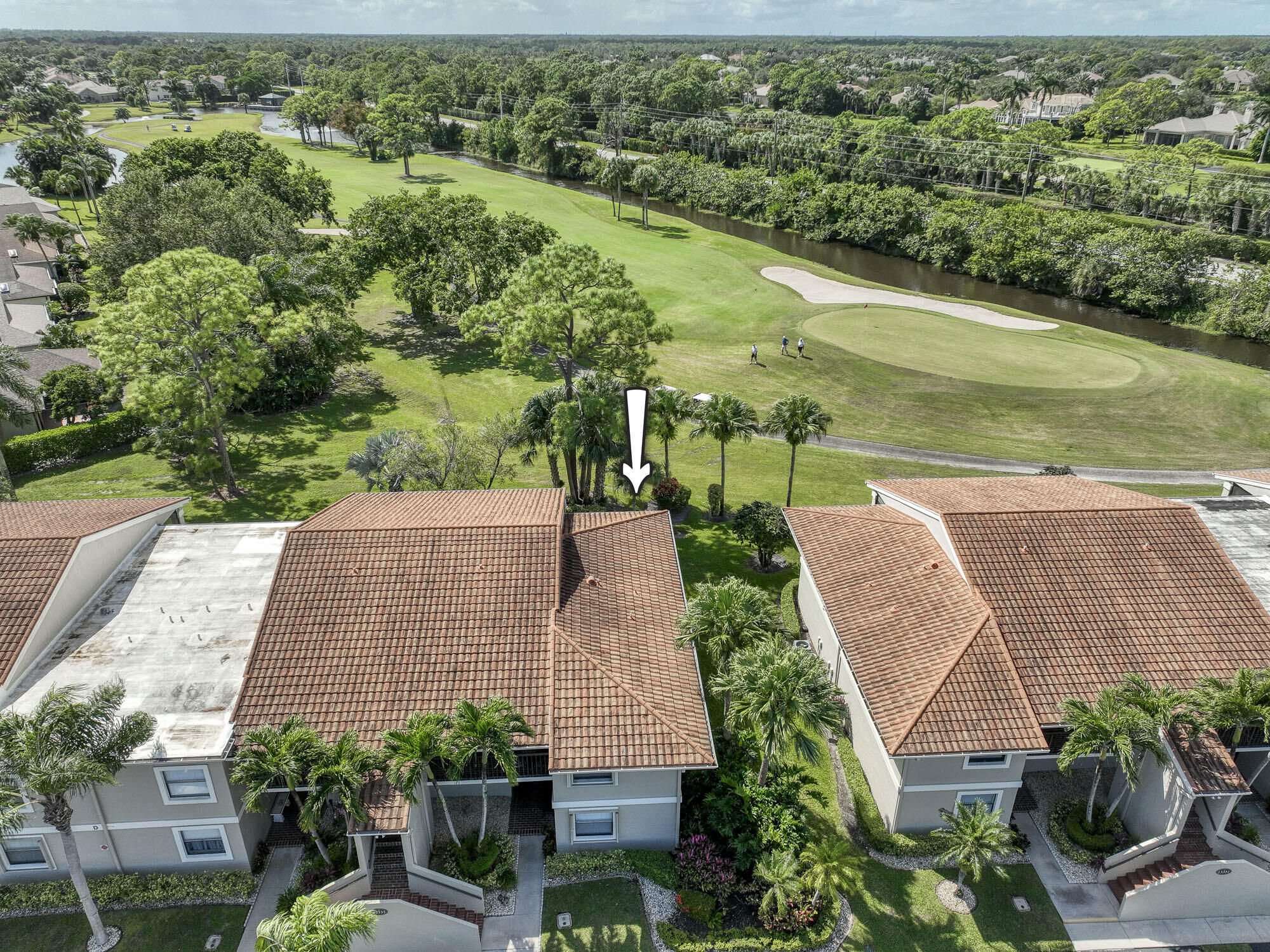 an aerial view of a house with a yard and lake view