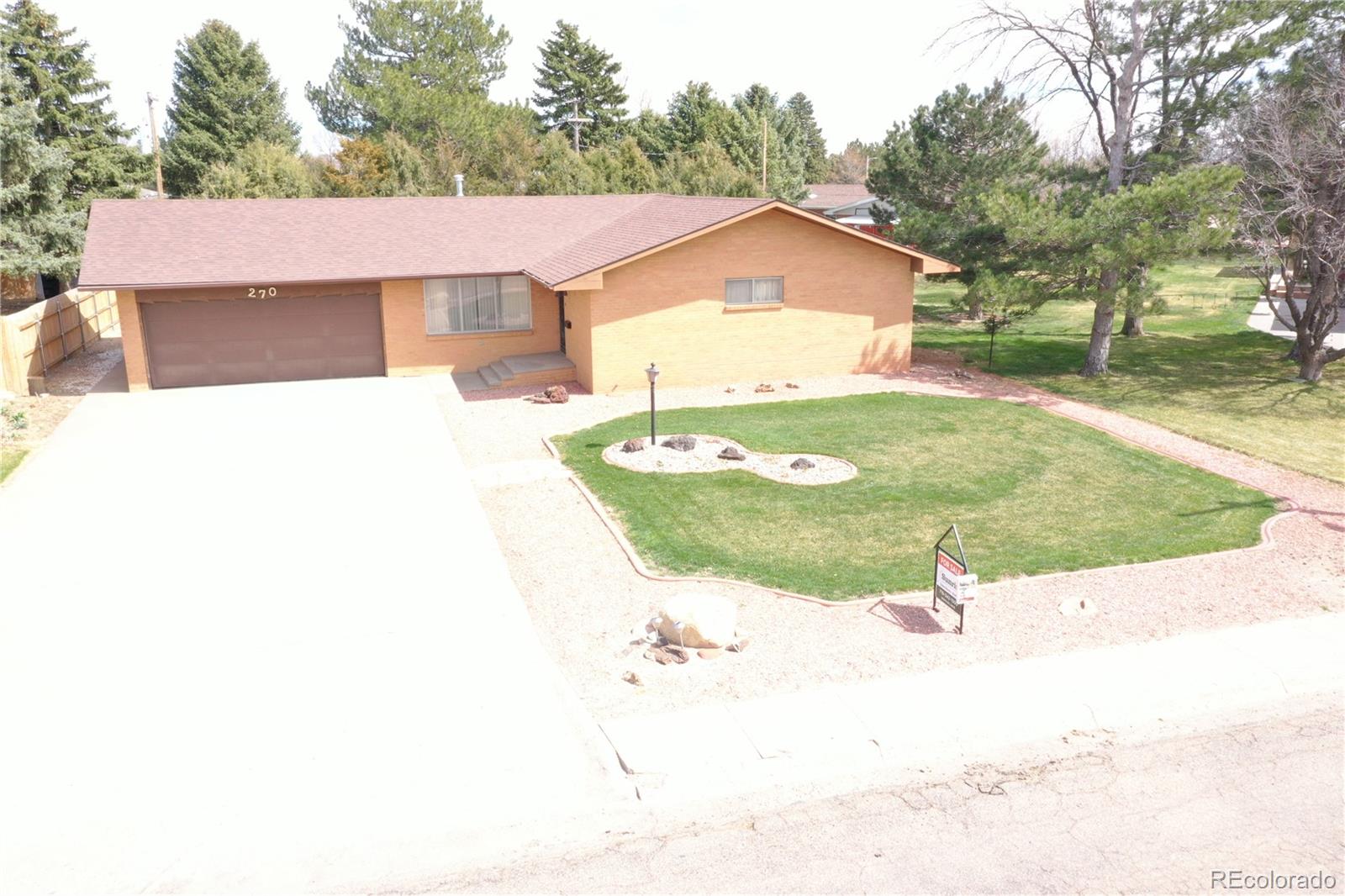 a view of a house with a yard and garage