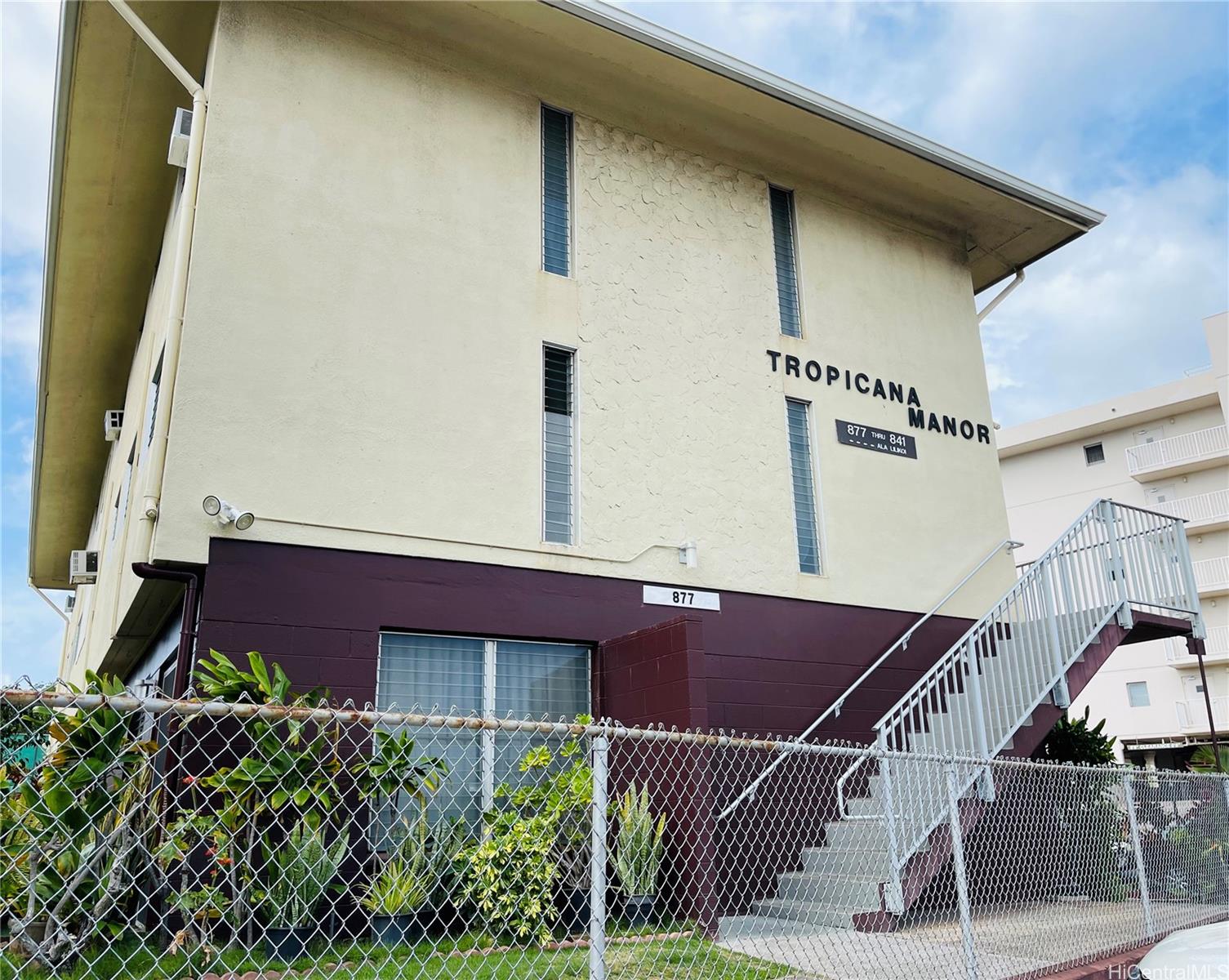 a balcony with next to a yard