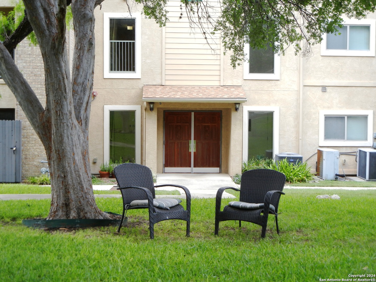 a view of a house with backyard porch and sitting area