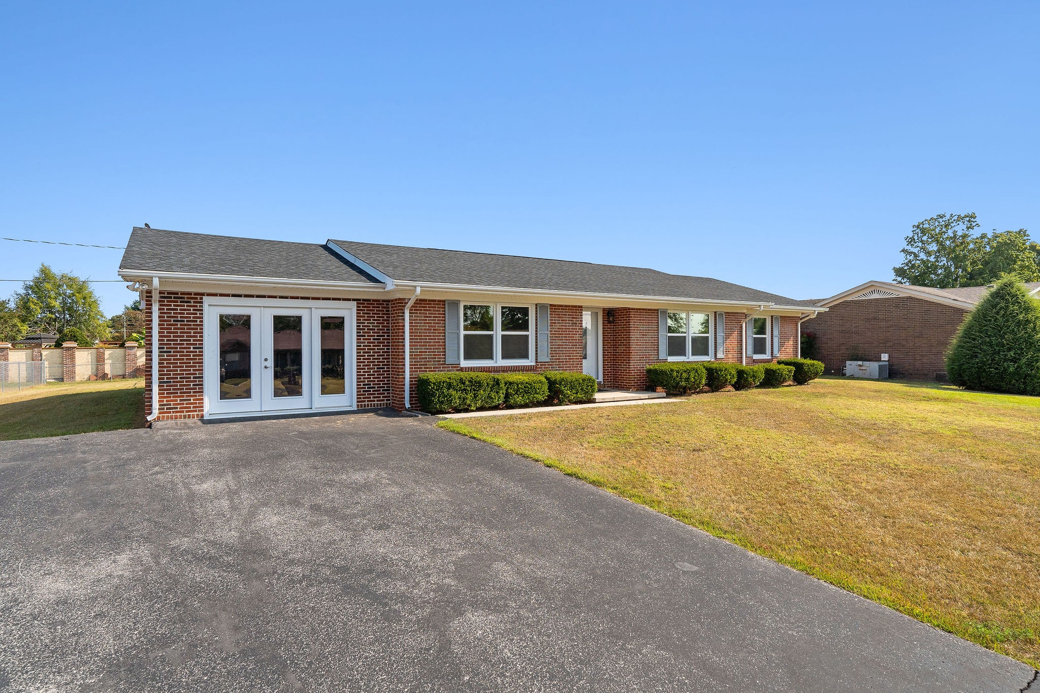 front view of a house next to a yard