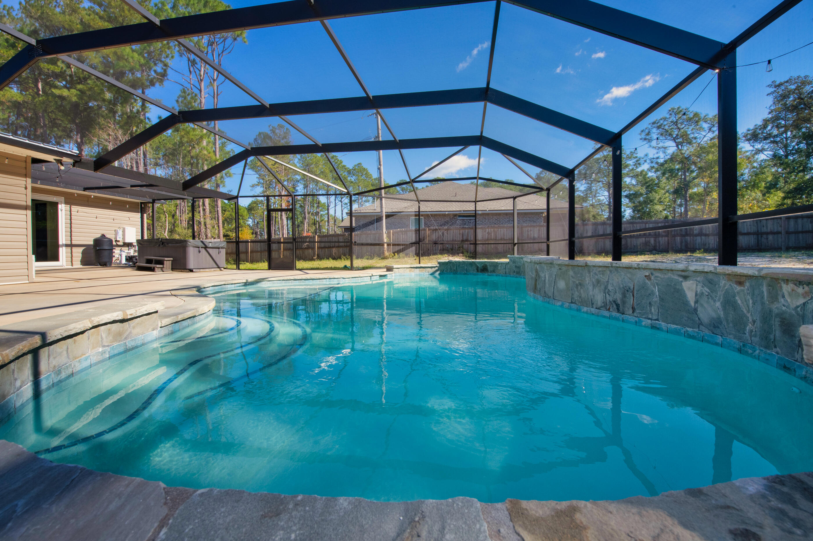 a view of a swimming pool with a yard