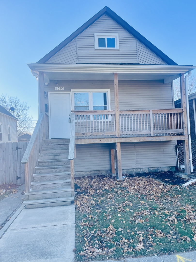 a view of a house with wooden fence