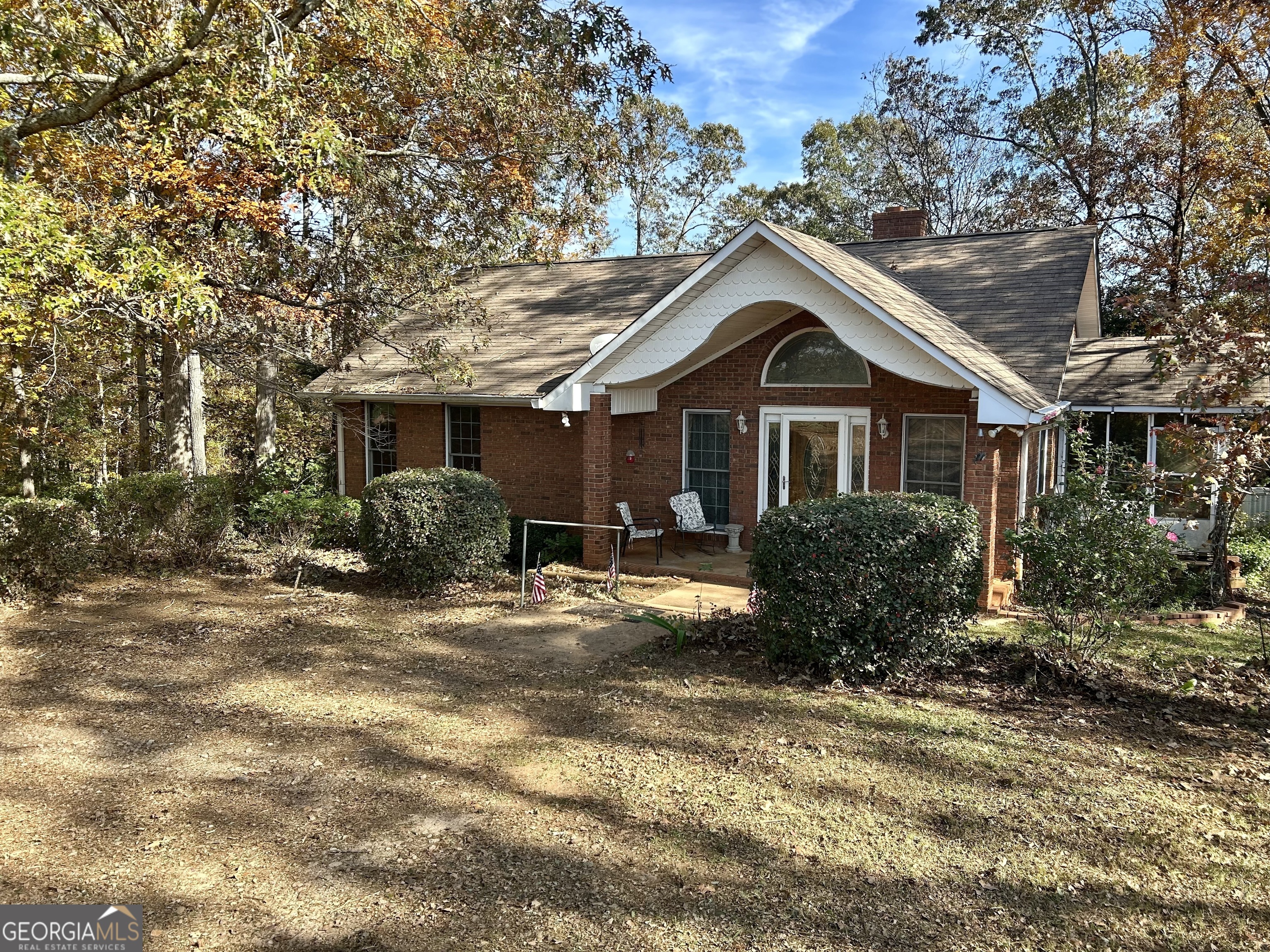 a front view of a house with yard and trees