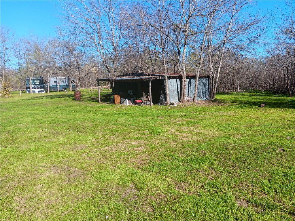 a view of a backyard with large trees