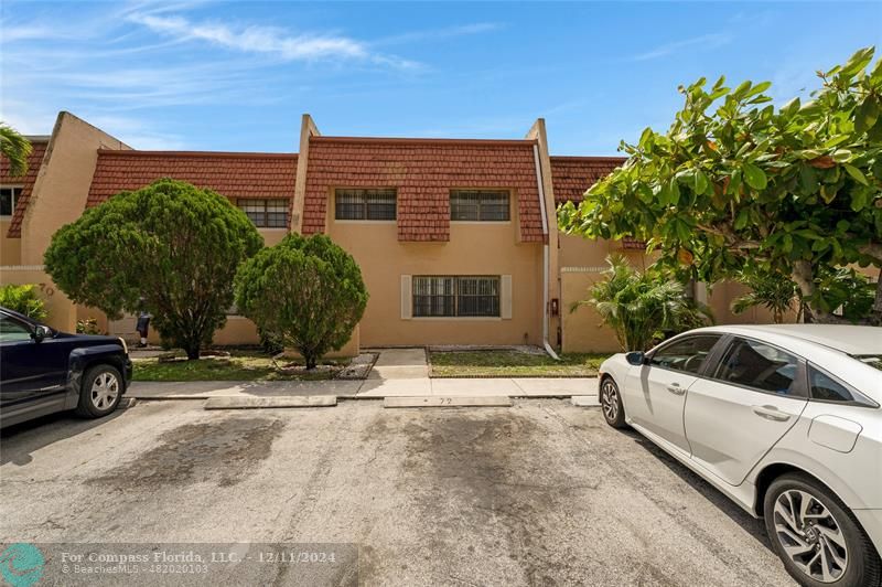 a view of a car parked in front of a house