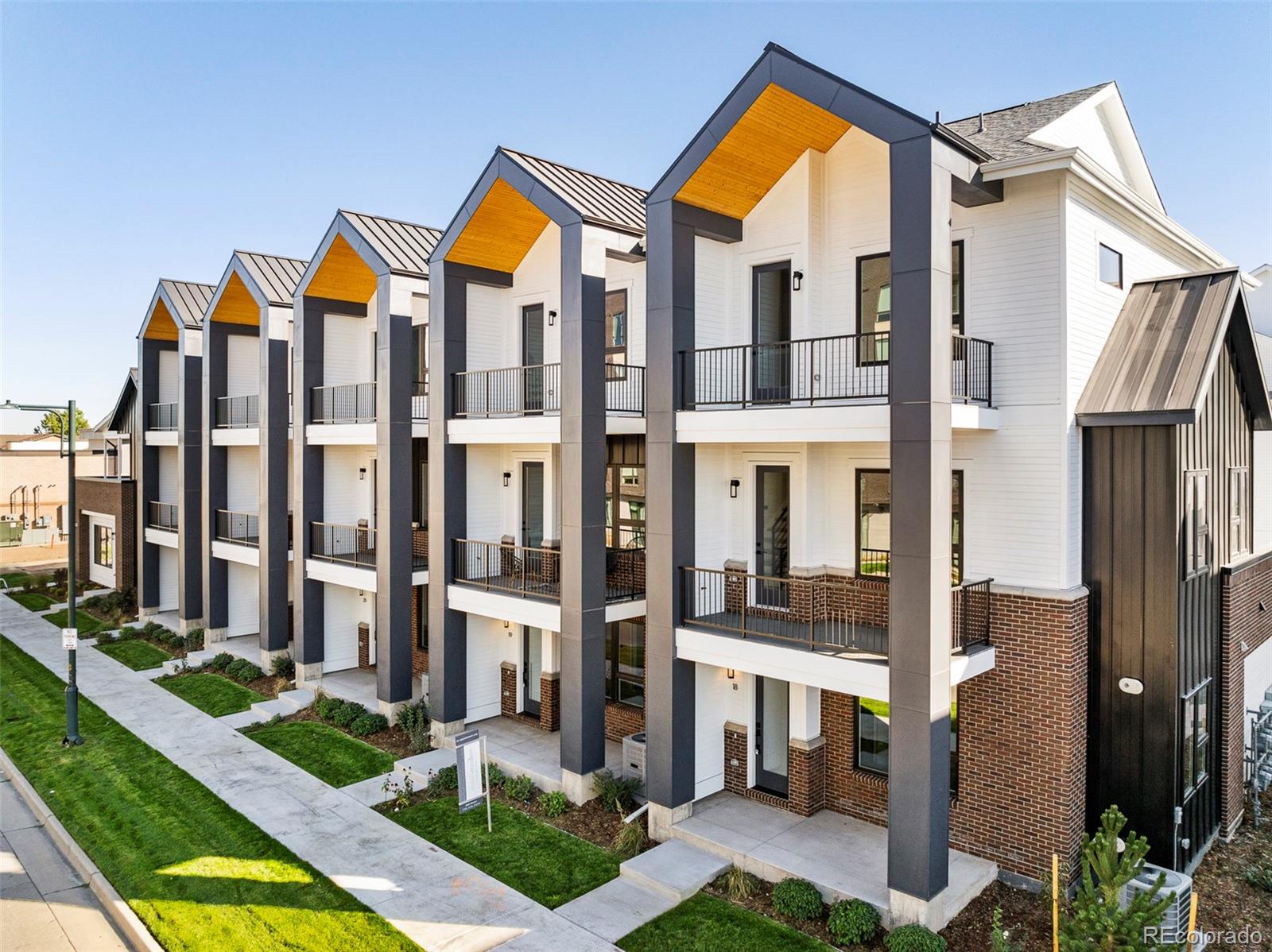 a view of residential houses with yard and swimming pool