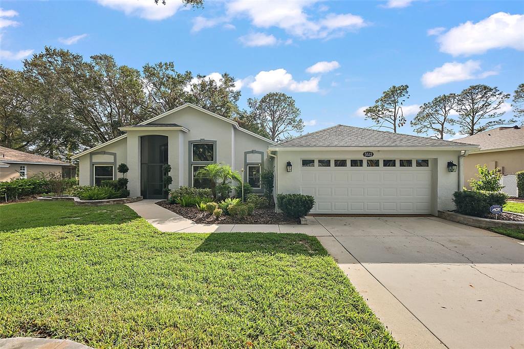 a front view of a house with a yard and garage