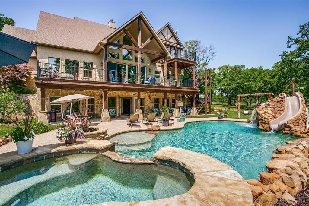 a view of a house with swimming pool and sitting area