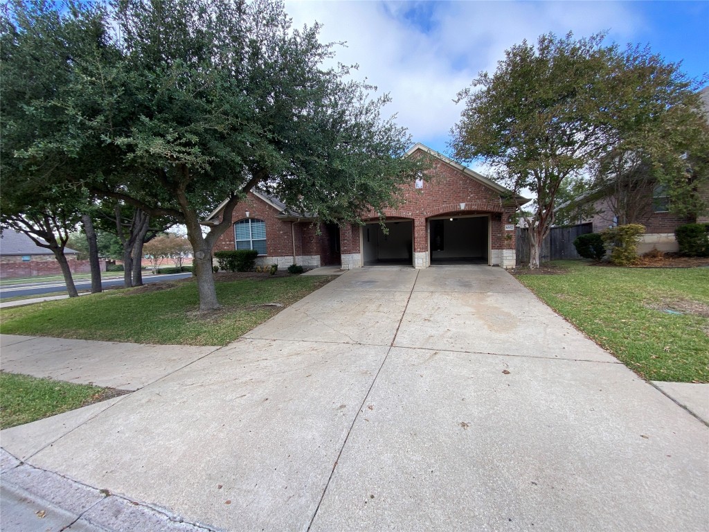 a front view of house with yard and green space