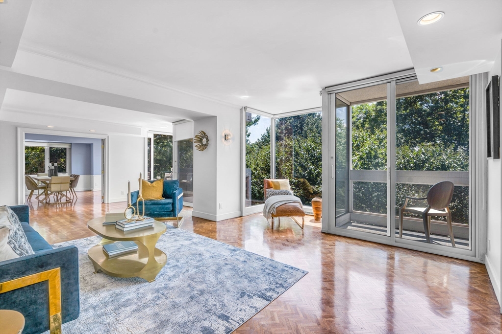 a living room with patio furniture and a large window