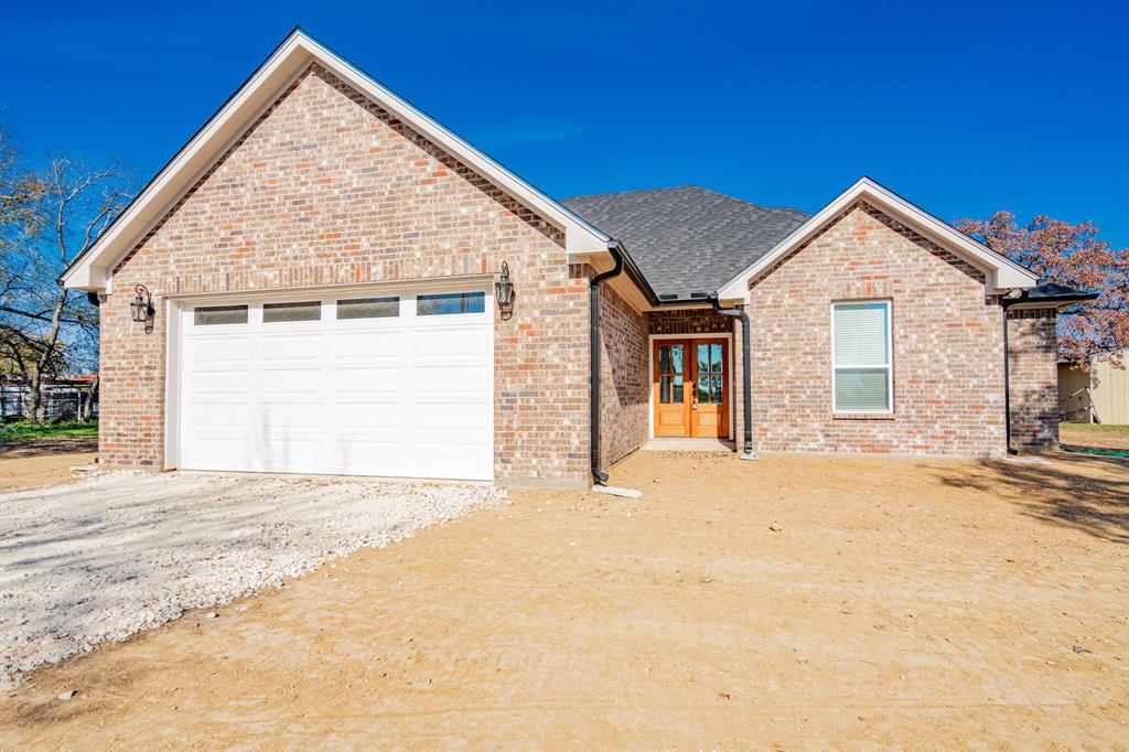 a view of a house with a yard and garage