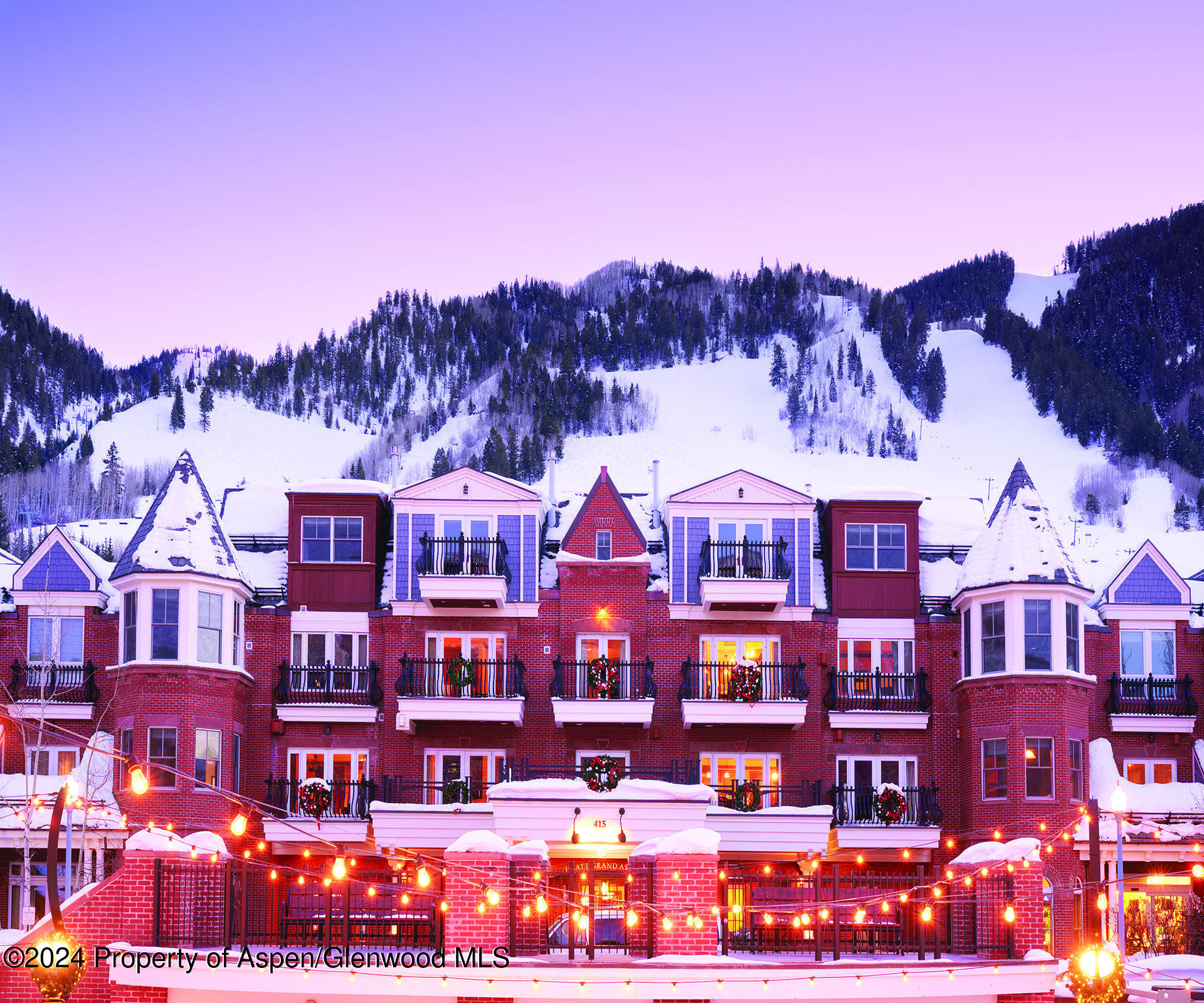 a front view of a building with a lot of mountains