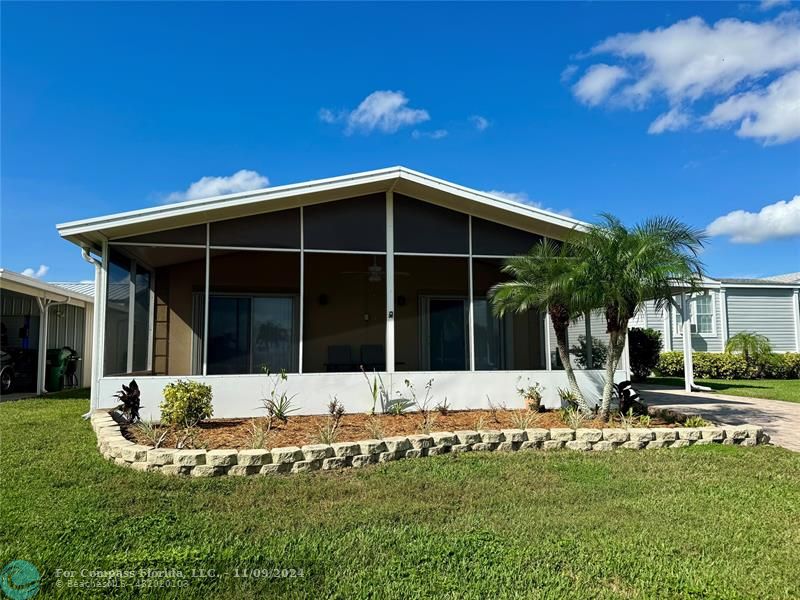 a view of a house with yard and sitting area