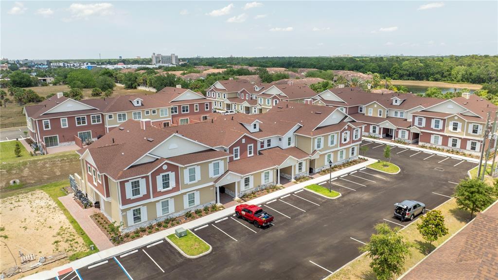 an aerial view of residential houses with outdoor space and ocean view