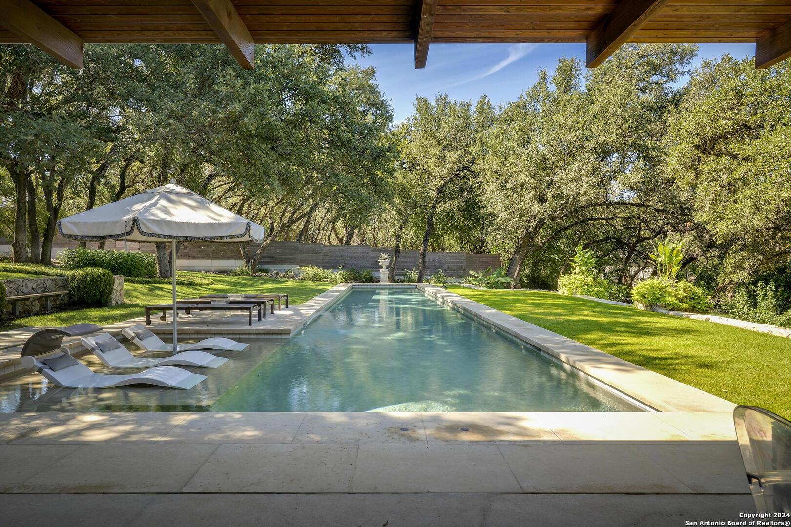 a view of swimming pool from a lounge chair