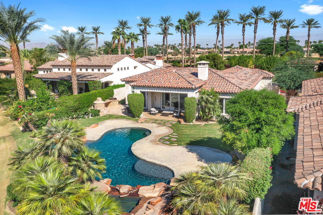 a swimming pool with outdoor seating and yard