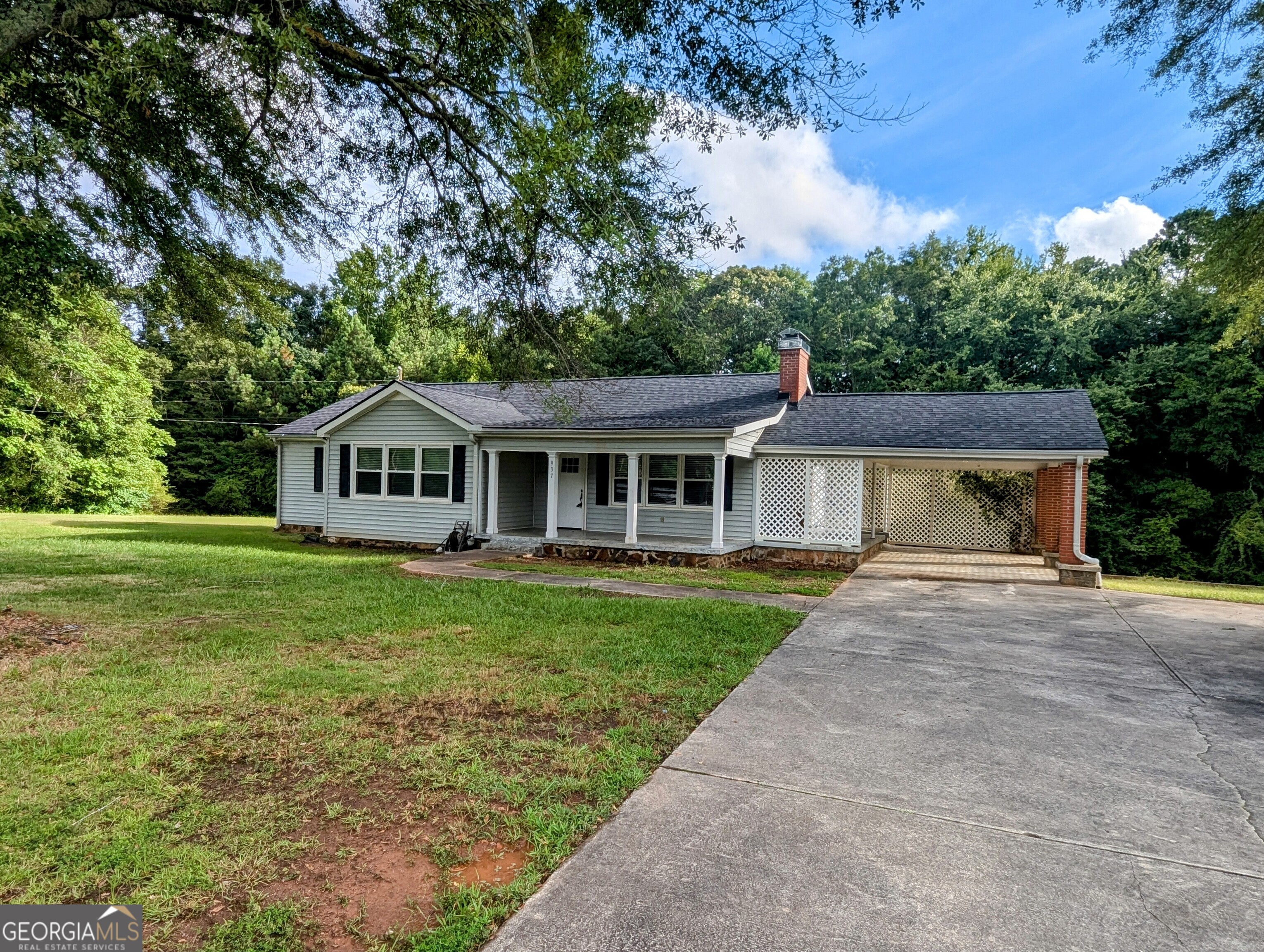 a front view of house with yard and green space