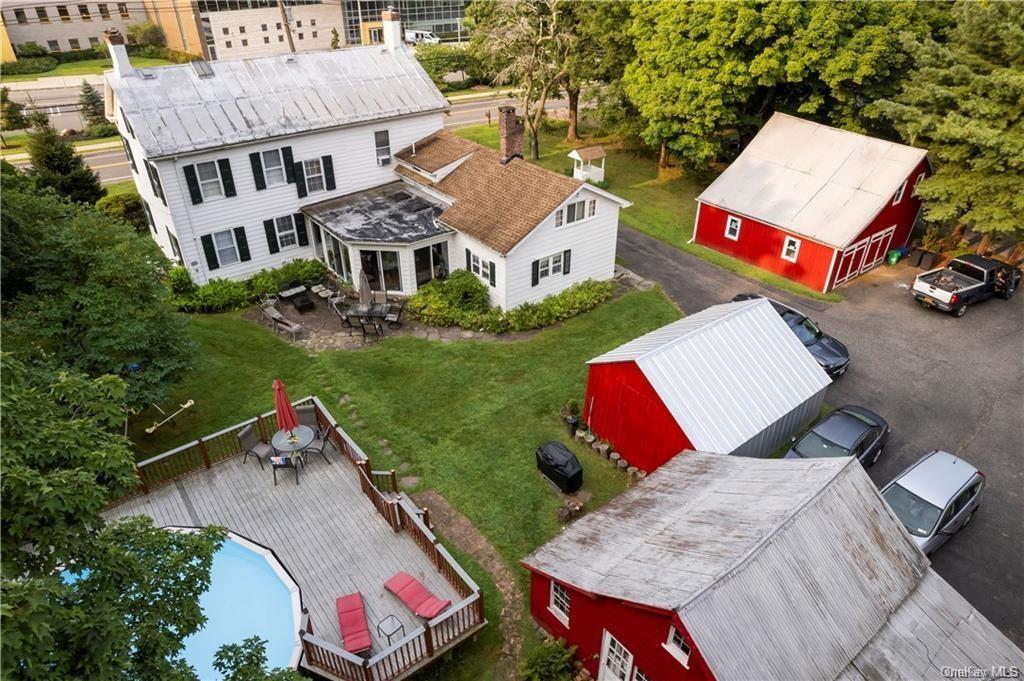 an aerial view of a house with yard and patio