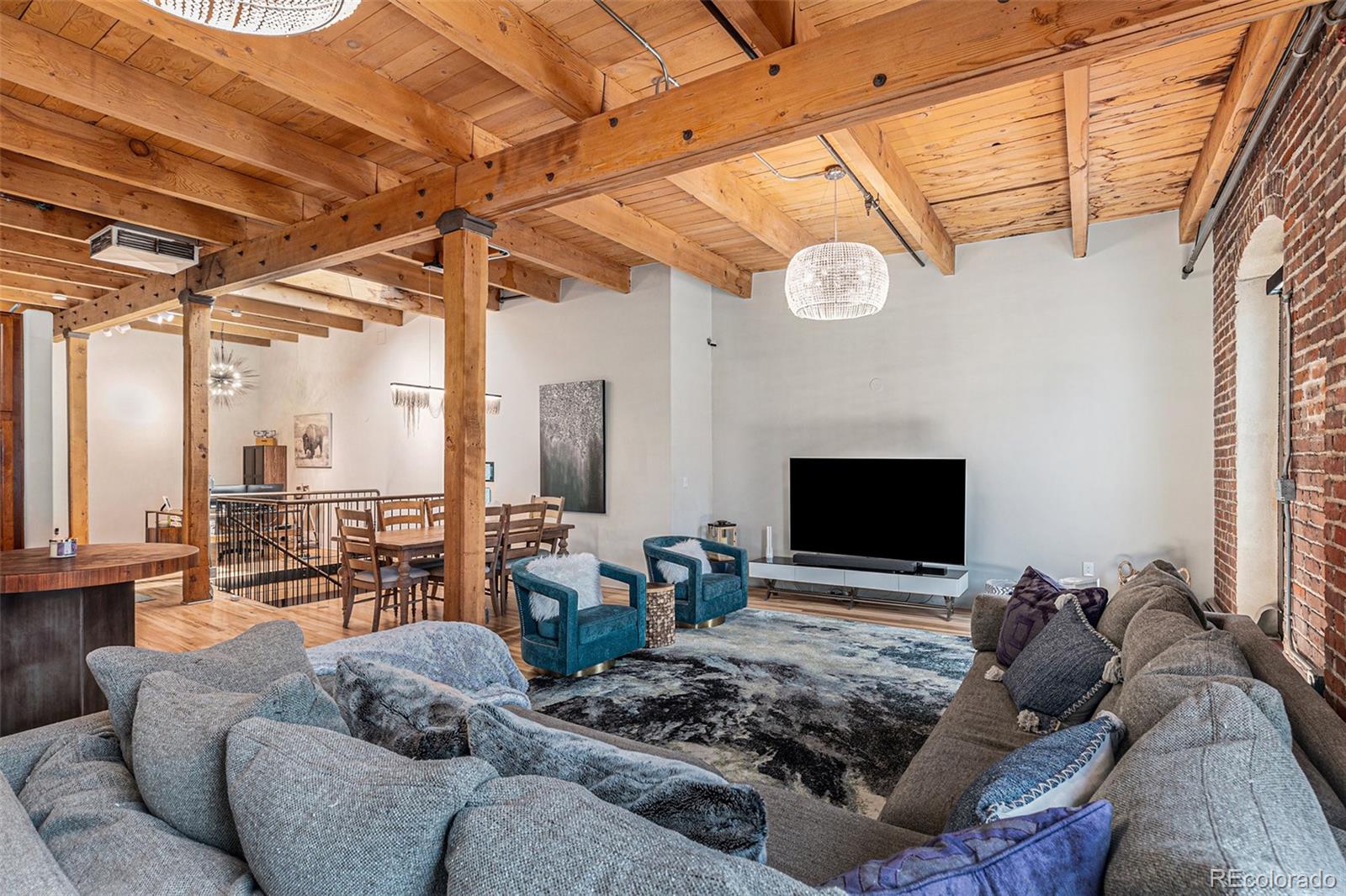 a living room with furniture a fireplace and a flat screen tv