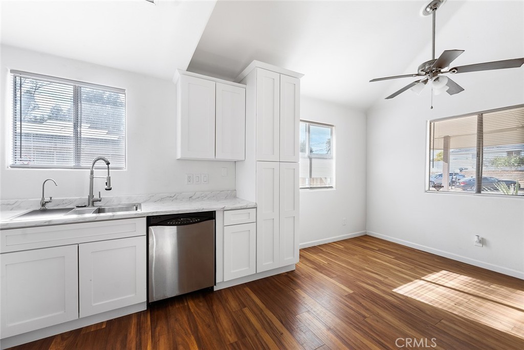 a kitchen with a sink window and cabinets