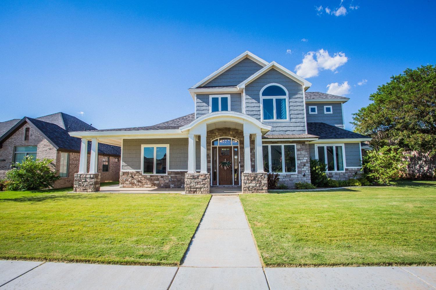 a front view of a house with garden and porch