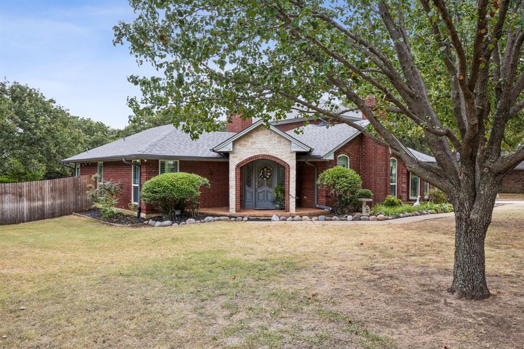 a front view of a house with yard and glass windows