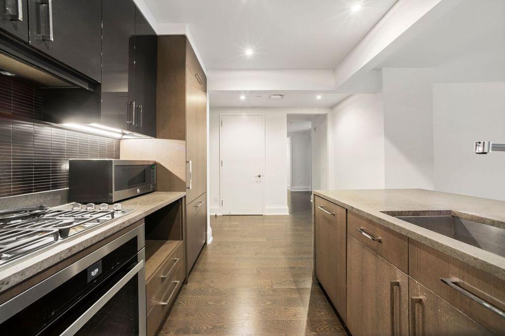 a kitchen that has a sink and a stove