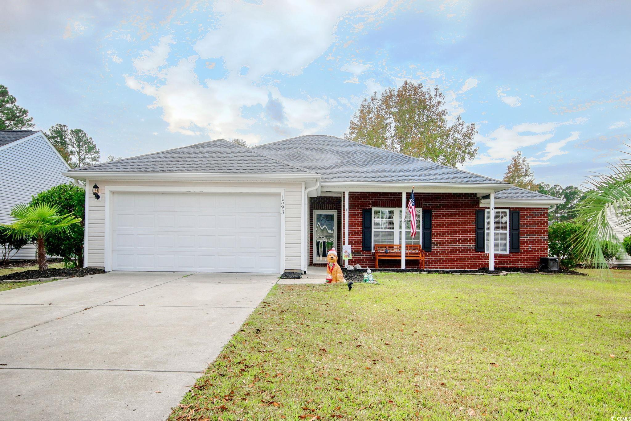 Ranch-style home with a garage and a front yard