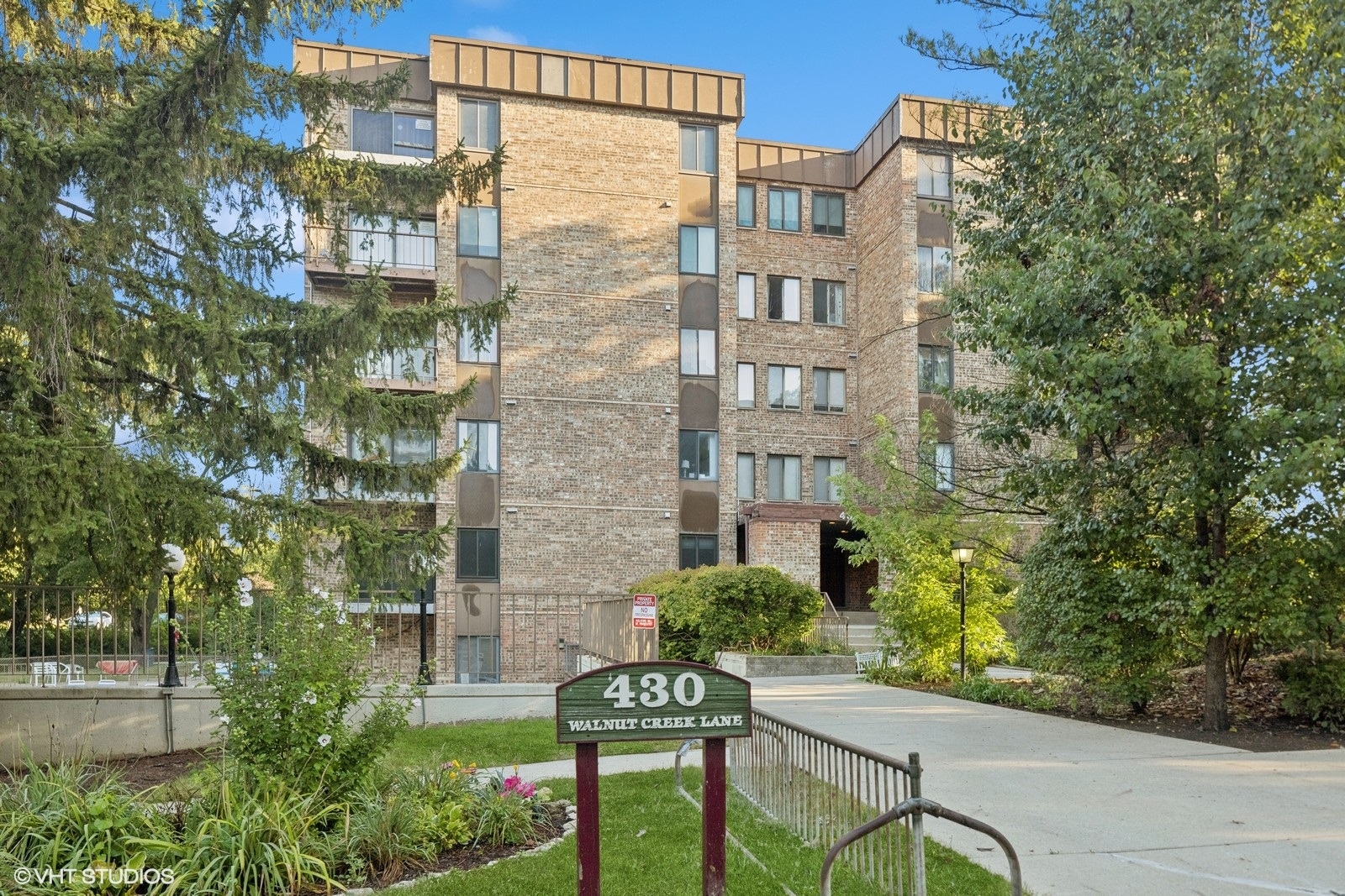 a view of a brick building next to a yard