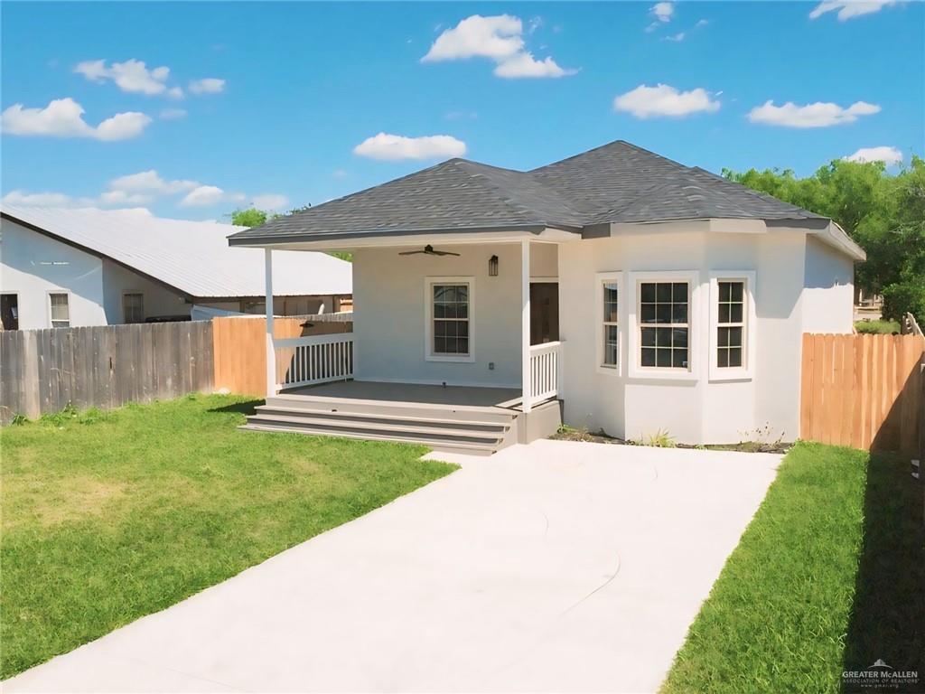 a front view of a house with a garden and yard