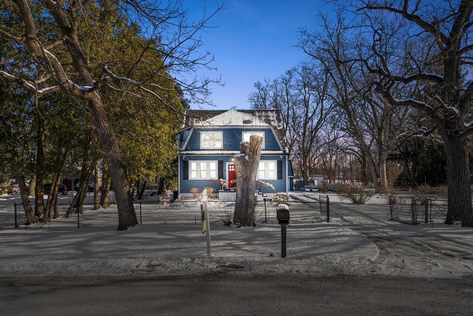 a front view of a building with trees