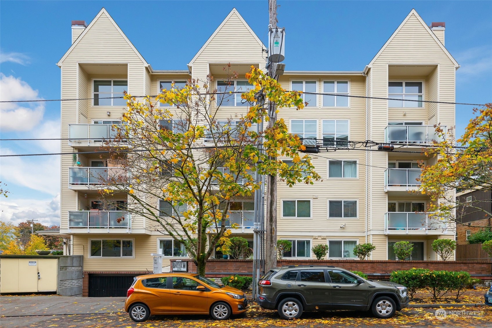 a front view of a residential apartment building with a yard