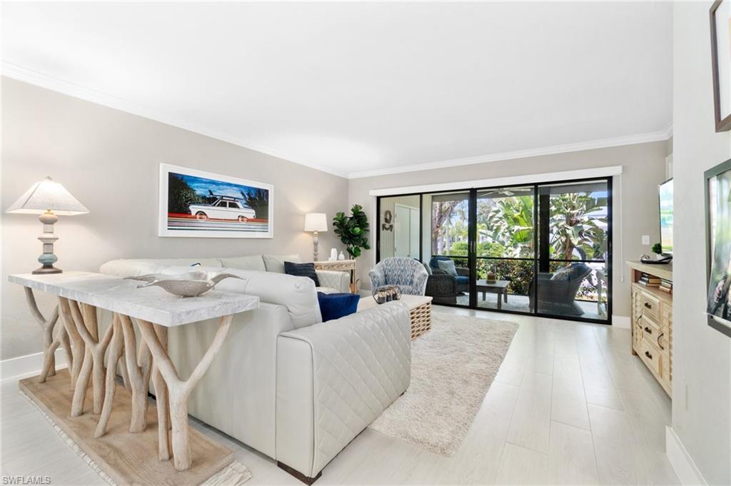 a living room with furniture large window and a table