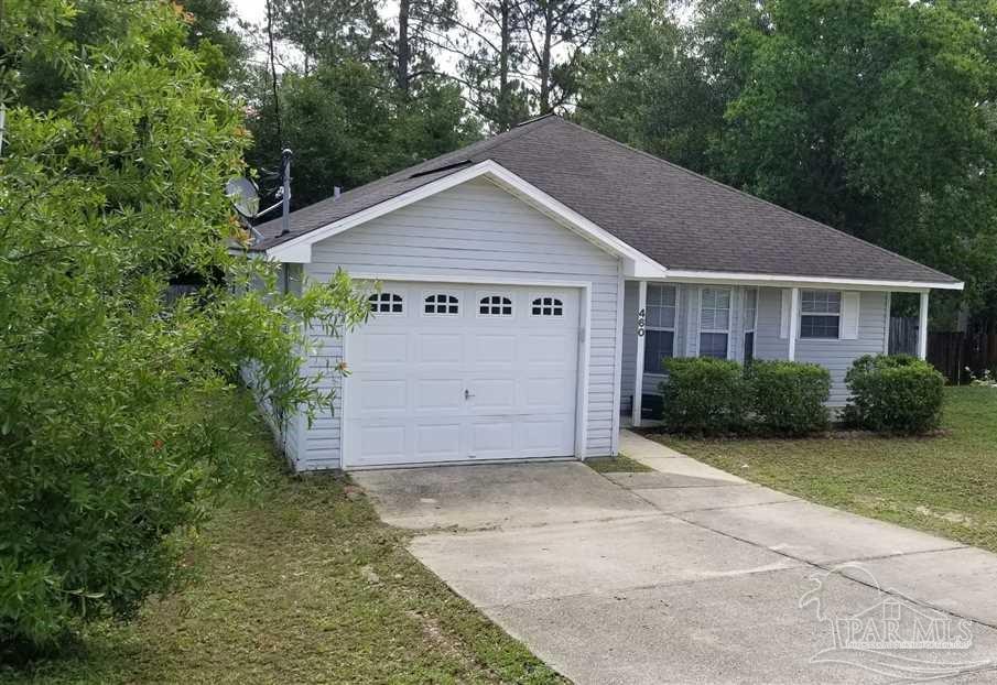 a view of a house with a yard and garage