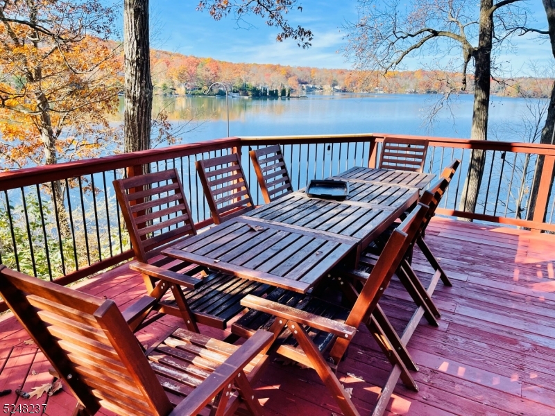 a view of a balcony with wooden floor and outdoor seating