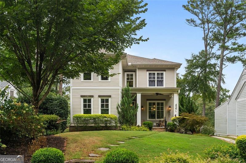 front view of a brick house with a yard