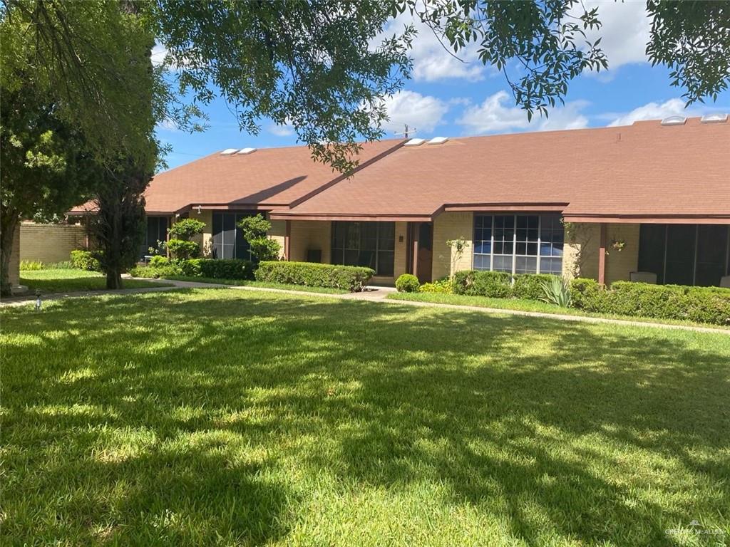 a front view of house with yard and trees