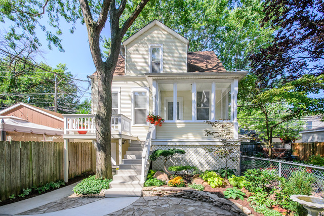 a front view of a house with a yard and fountain