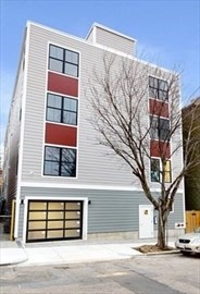 a front view of a house with a road