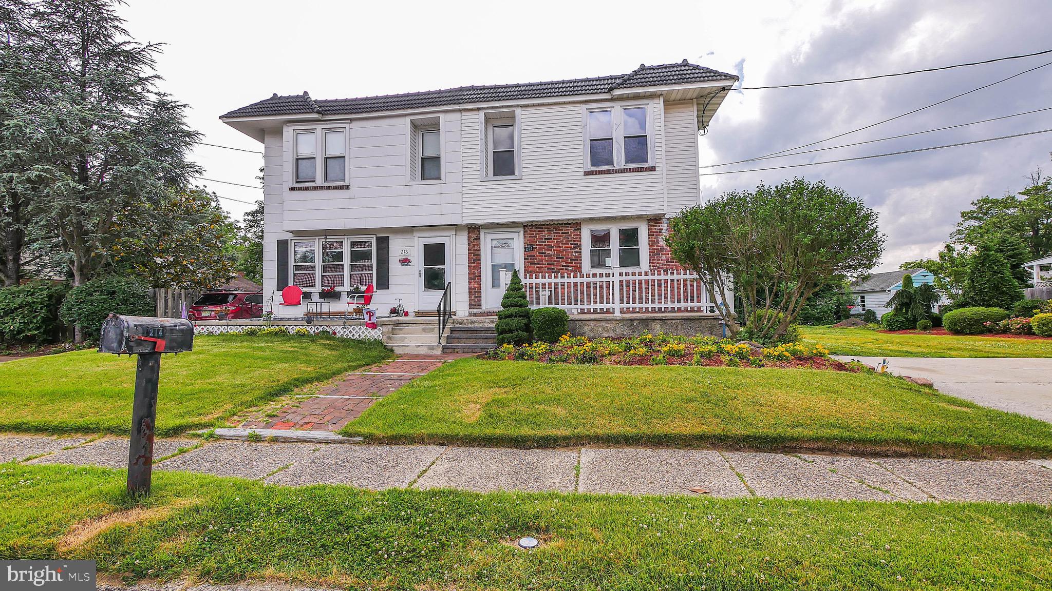 a front view of a house with a yard and porch